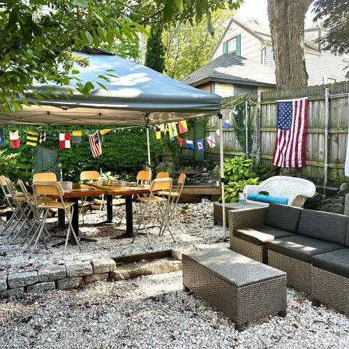 MOC HQ Portland backyard oasis — string lights, ivy-covered walls, outdoor seating