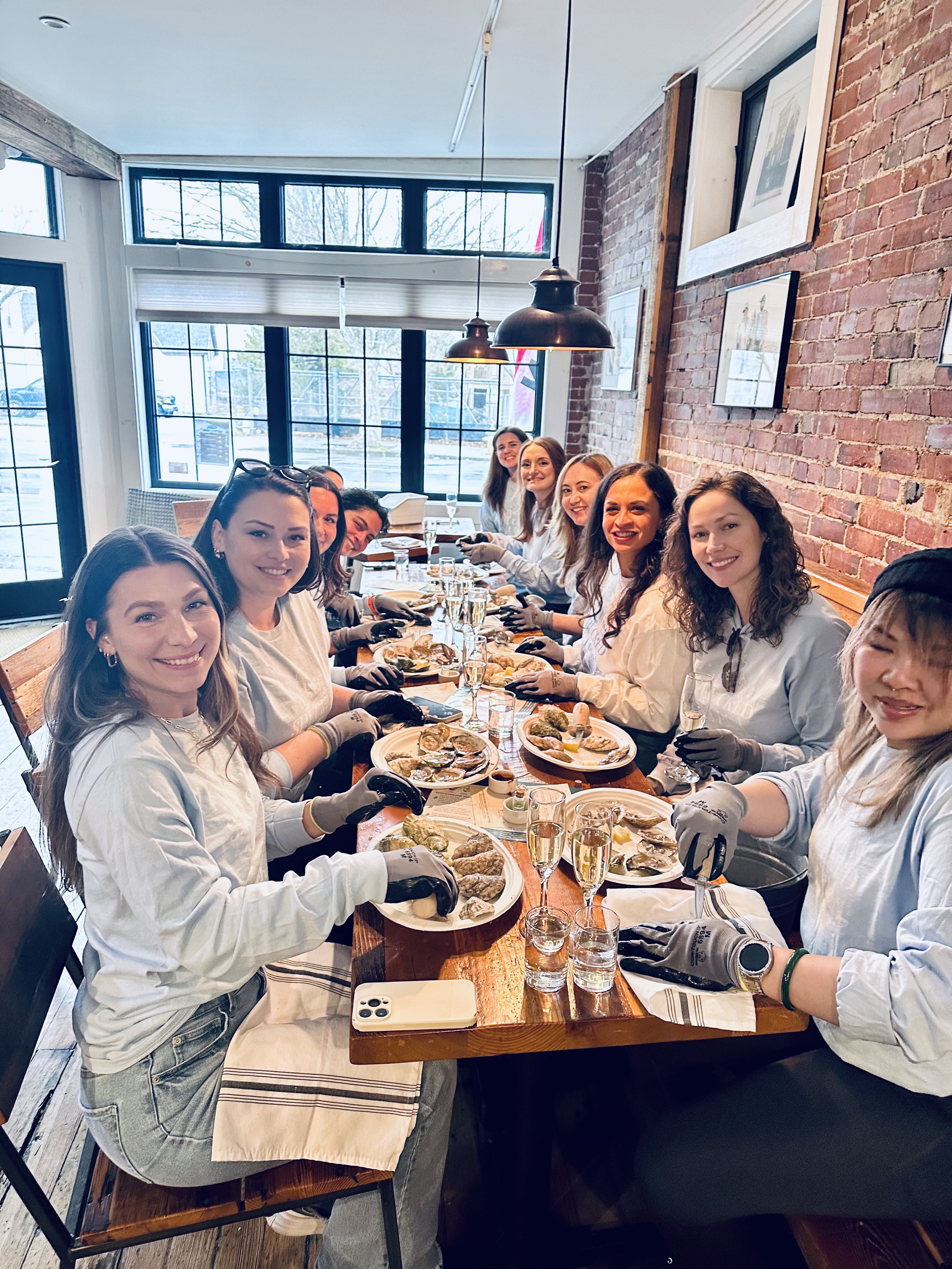 A group gathered for a shucking celebration at the Portland Raw Bar