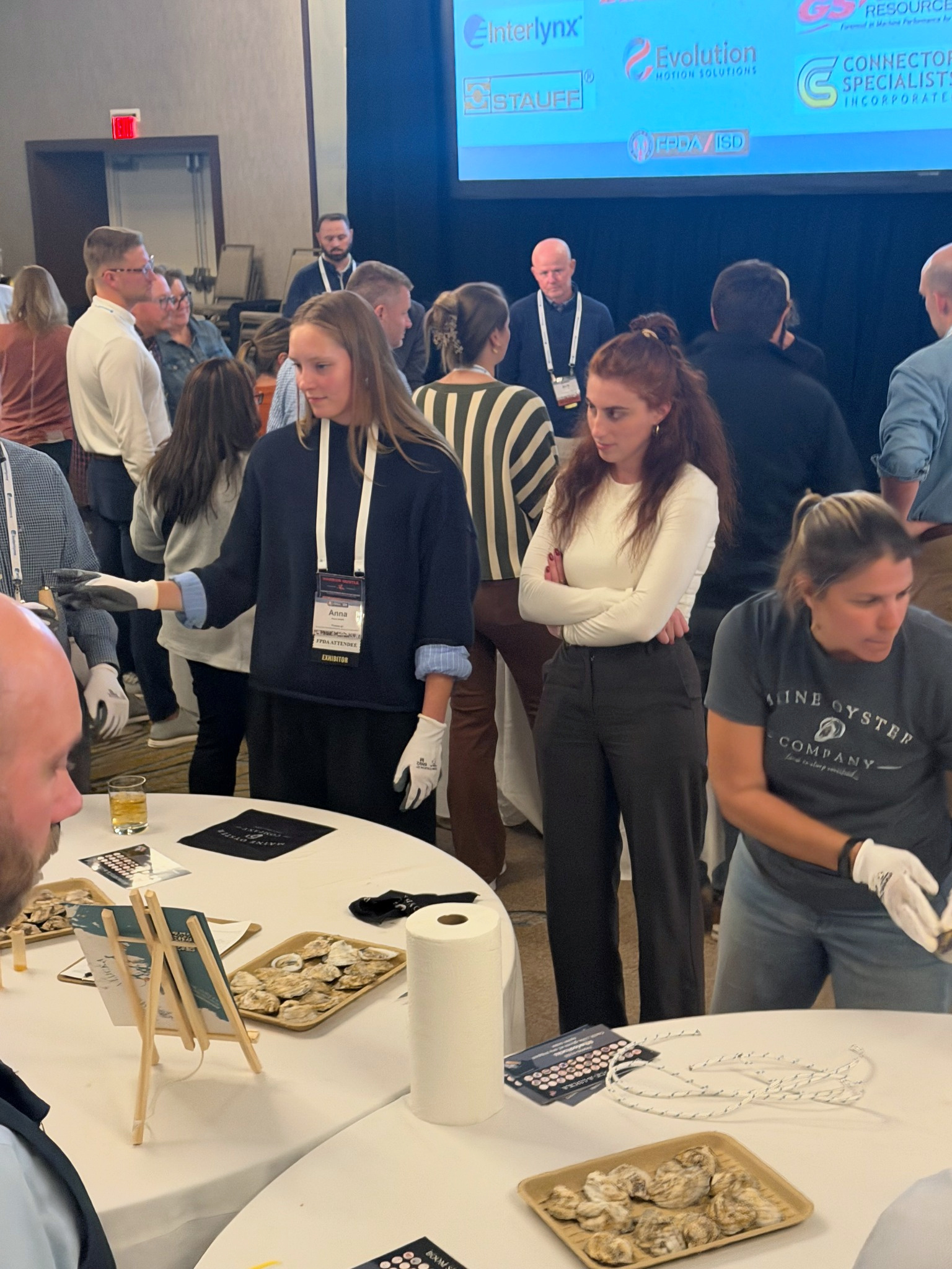 Participants sharing a moment during a corporate oyster-shucking experience